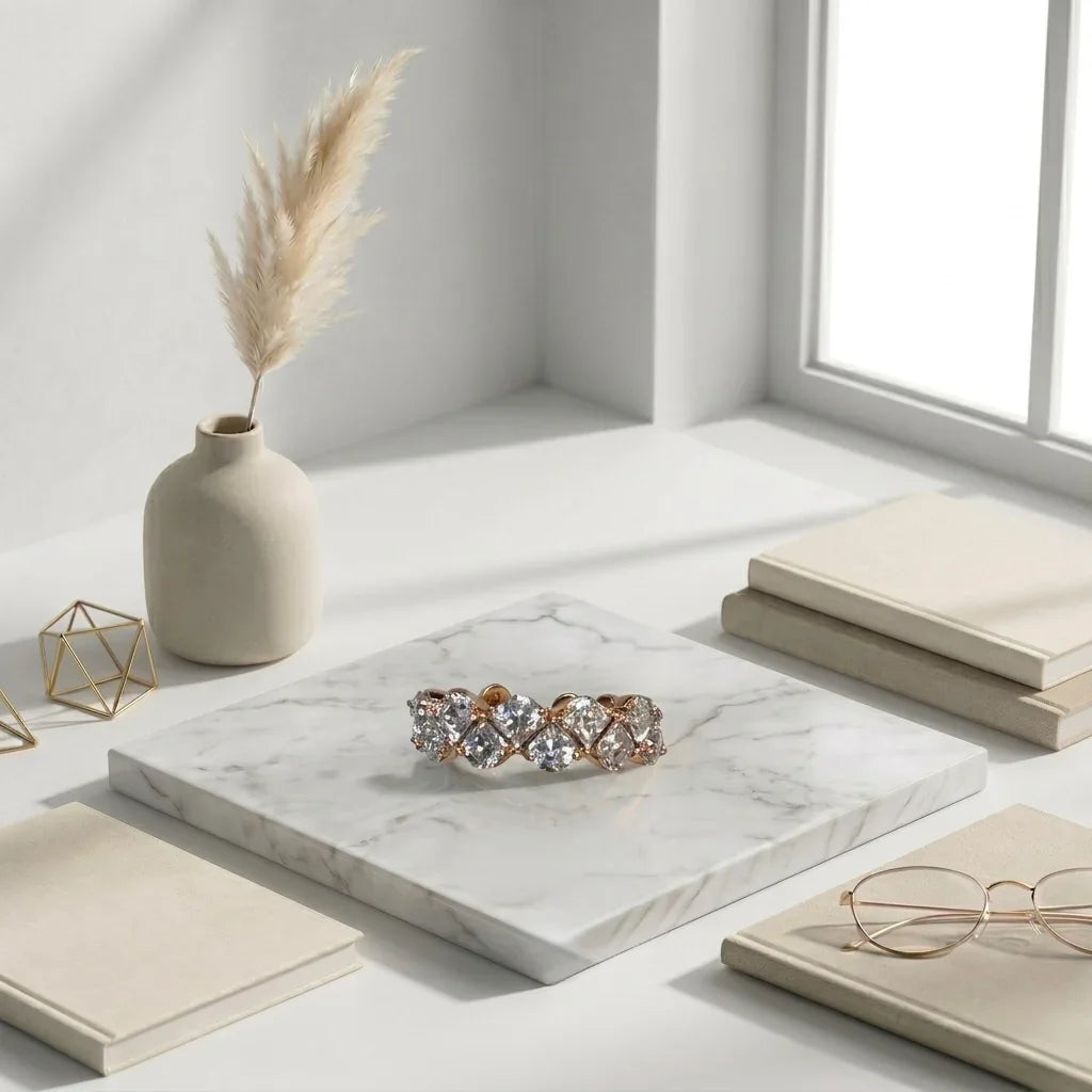 Elegant American Diamond ring with rose gold setting, displayed on marble slab with books and vase
