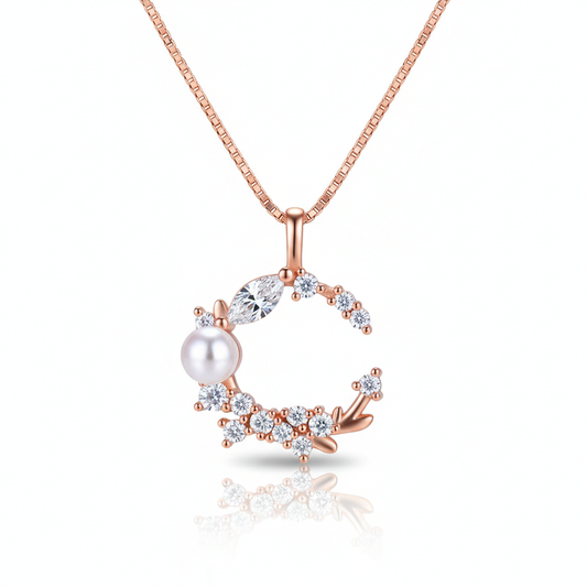 Rose gold necklace with a pearl and diamond pendant on a white background