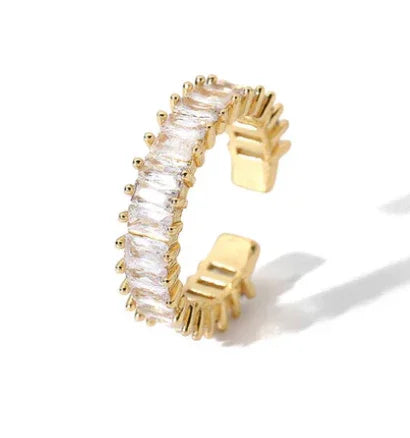 Gold-toned American Diamond eternity ring with baguette-cut stones and textured prongs
