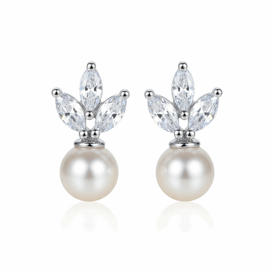 Pair of pearl earrings with crystal-like stones on a white background