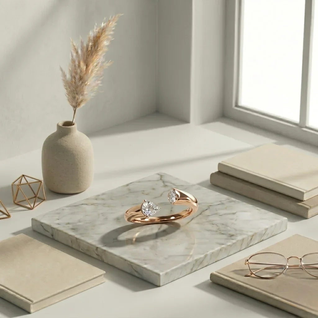 Elegant rose gold ring with heart-shaped diamond, styled on marble with books and vase
