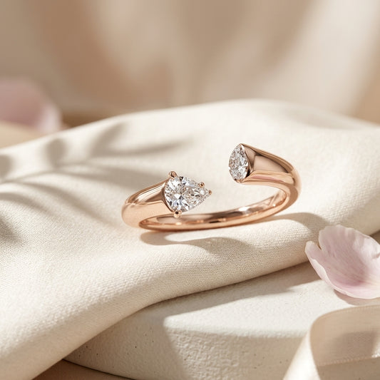 Pear cut diamond engagement ring in rose gold with side accent stone, elegant bridal jewelry
