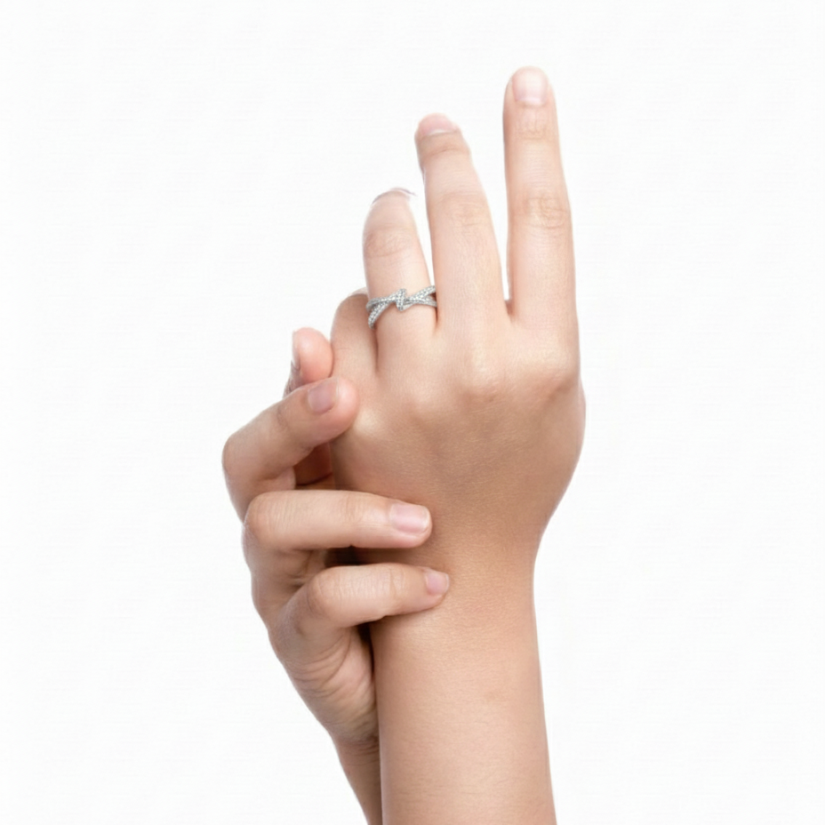 Hand wearing a silver ring on a white background
