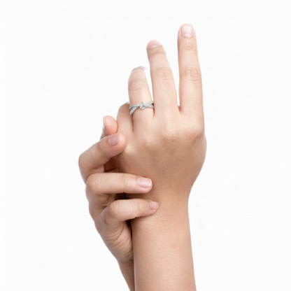 Hand wearing a silver ring on a white background