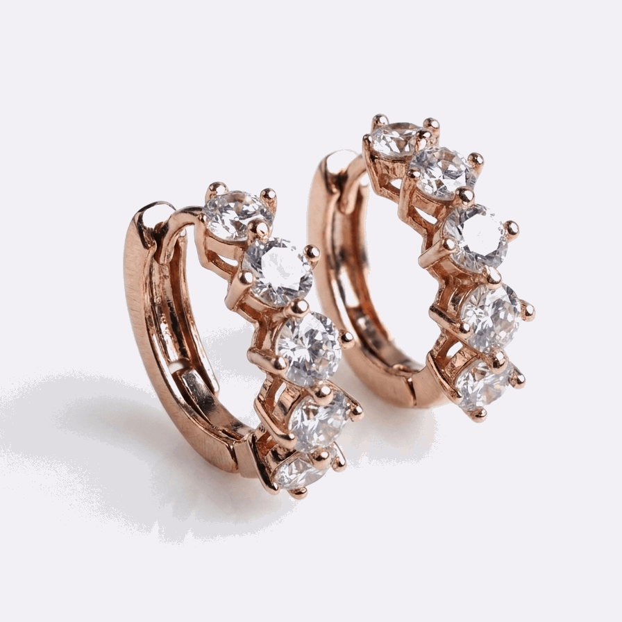champagne gold hoop earrings with clear gemstones on a light gray background
