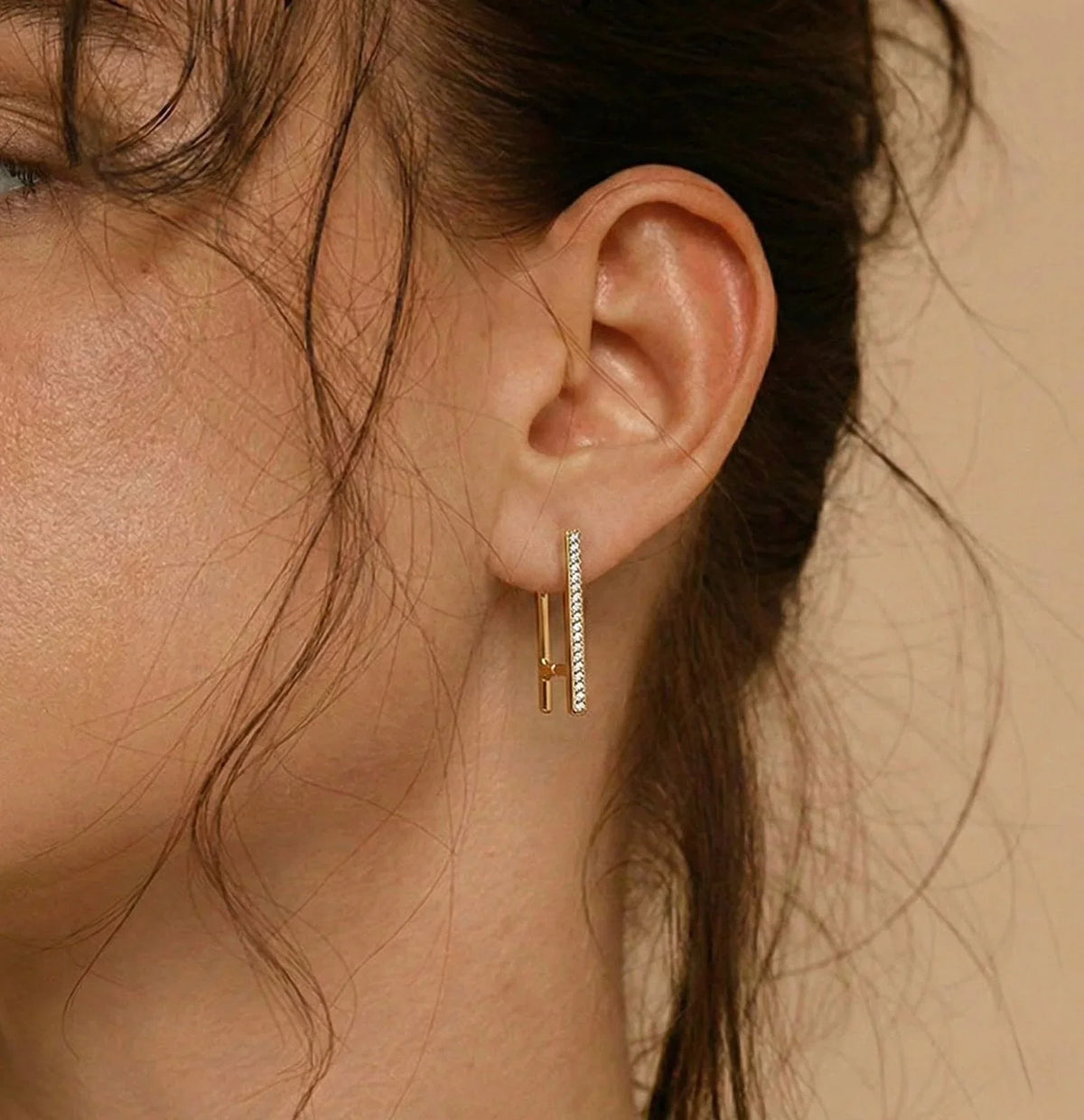 Gold bar earring with sparkling stones, modern minimalist design for everyday wear