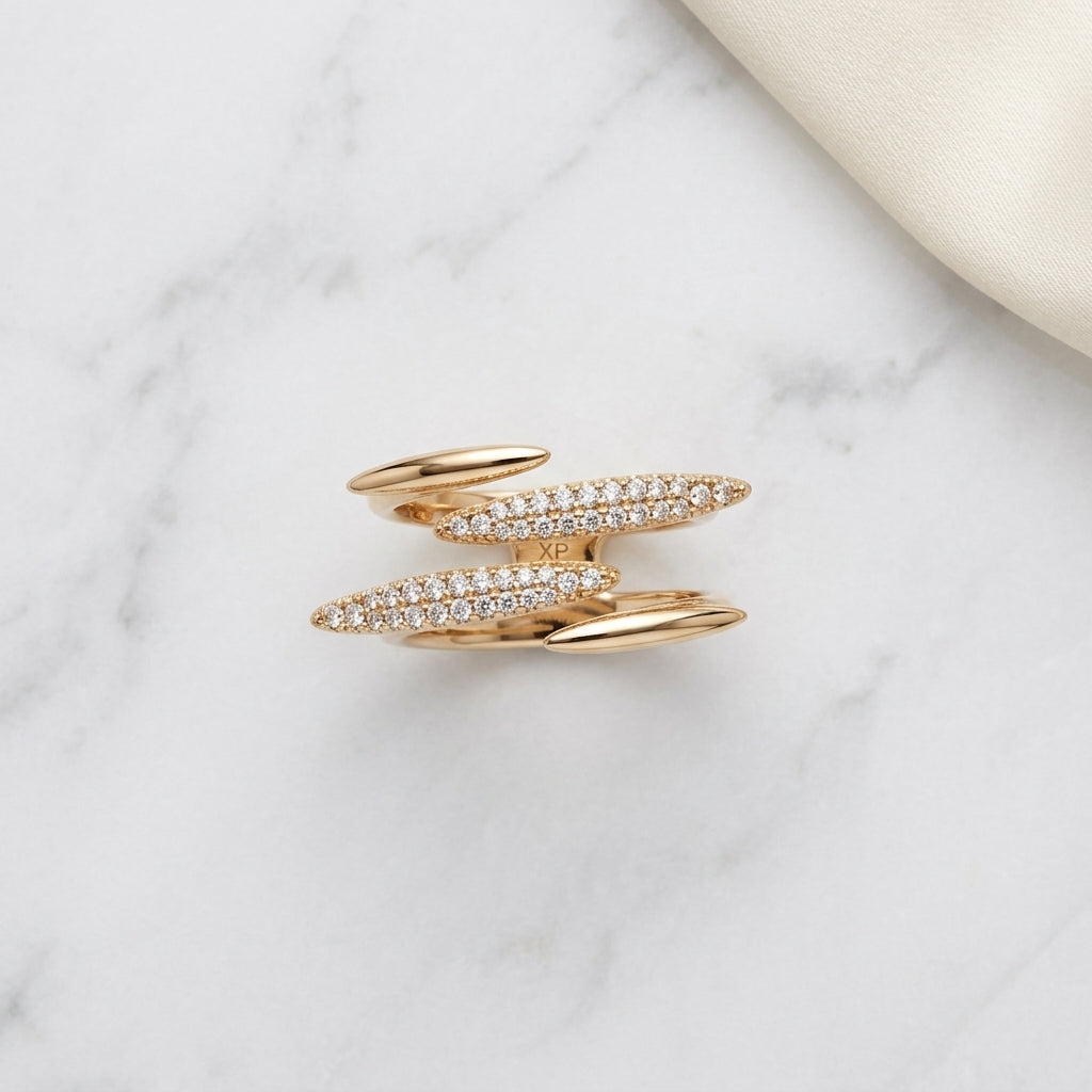 Elegant gold ring with sparkling diamond bands on marble surface