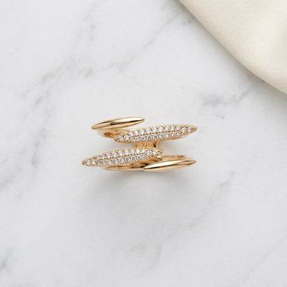 Elegant gold ring with sparkling diamond bands on marble surface