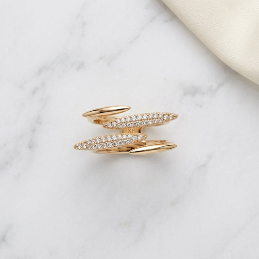 Elegant gold ring with sparkling diamond bands on marble surface